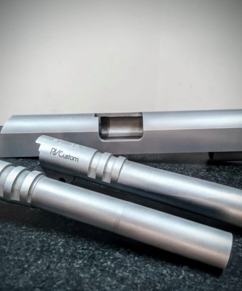 Esempi di canne 1911, 9mm standard barrel e .40S&W Bull Barrel con carrello semilavorato sullo sfondo